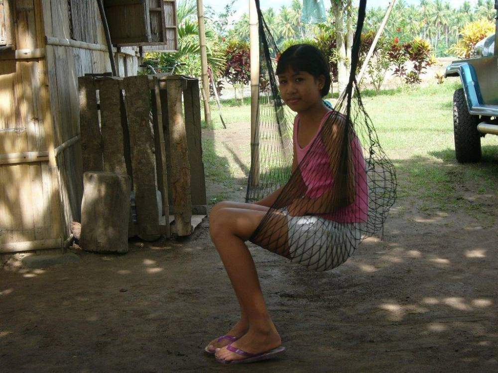 Jelyn - Pretty, Young Filipina Girl Sitting on a Hammock