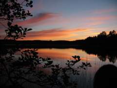 A beautiful sunset reflected in the calm waters of a lake