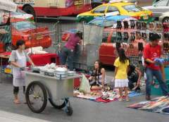 Attractive young lady selling shoes on a Bangkok street