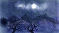 Dark sky in winter with a full moon and some mountains