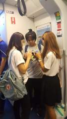 And no - they are NOT texting each other! Thai school girls deeply engrossed in their cellphones