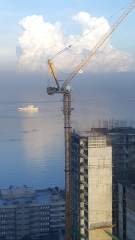 A crane, a cloud and a ship