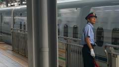 Platform Inspector watching attentively as the train pulls out of the station