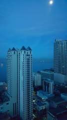 La Nobleza Terrazas and the 1322 Golden Empire high-rise building overlooking Manila Bay at dawn