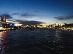A sunset over London reflected in the waters of the River Thames