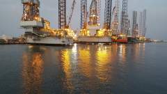 Oil rigs at Hamriyah with their lights reflecting in the water
