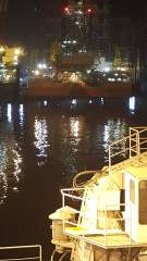 Hamriyah port at night with lights reflecting off the smooth waters of the harbour