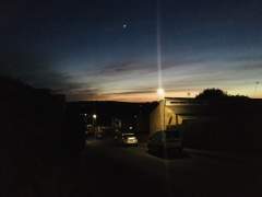 Sunset, lamplight and Venus across Worldham Hill, Hampshire, England