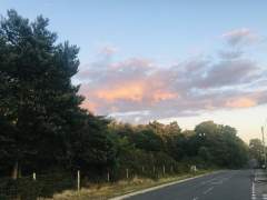 The setting sun lights up clouds.