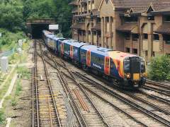 South Western Railway Class 450 Desiro emerges from Chalk Tunnel at Guildford